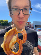 a photo of the author eating a pretzel
